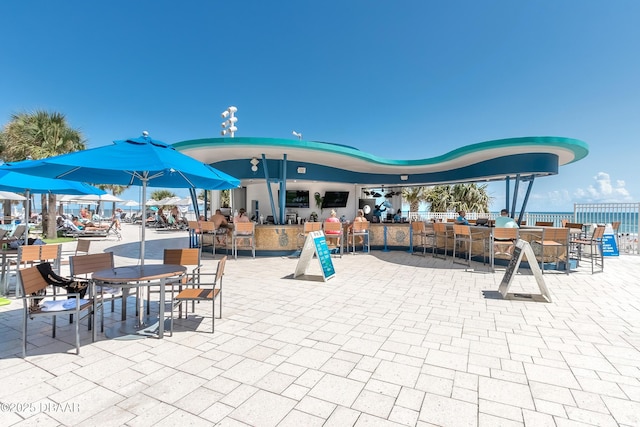 view of property's community with outdoor dry bar and a patio area