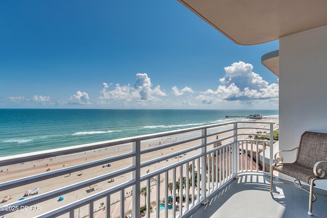 balcony with a view of the beach and a water view