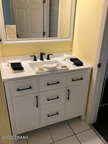 bathroom with tile patterned floors and vanity