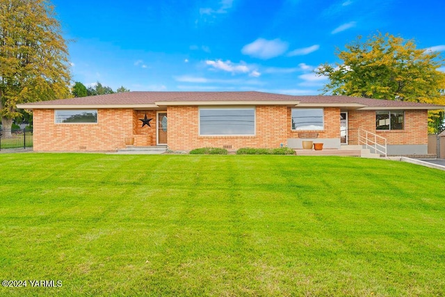 single story home with a front lawn, fence, and brick siding