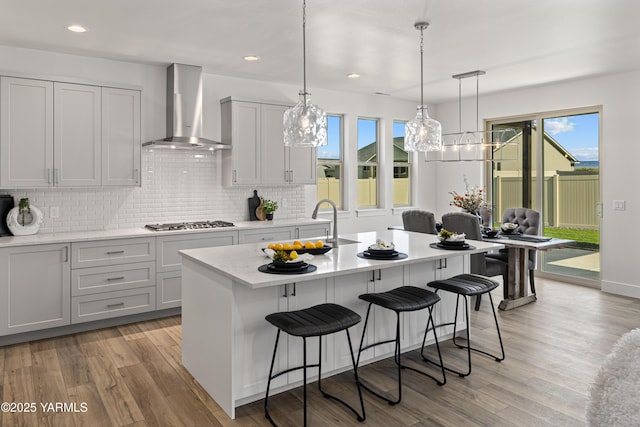 201 E Chinook Rd Lot # 10, Ellensburg, WA 98926 - kitchen with wall chimney range hood, stainless steel gas stovetop, a chandelier, light wood-type flooring, and recessed lighting