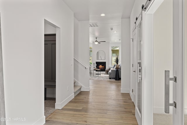 201 E Chinook Rd Lot # 10, Ellensburg, WA 98926 - corridor featuring a barn door, light wood finished floors, recessed lighting, stairway, and baseboards