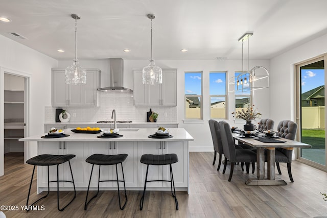 201 E Chinook Rd Lot # 10, Ellensburg, WA 98926 - kitchen featuring wall chimney range hood, light countertops, tasteful backsplash, a breakfast bar, and recessed lighting