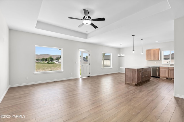 4608 W Larch Ave, Yakima, WA 98908 - unfurnished living room with a raised ceiling, light wood-type flooring, ceiling fan, and a chandelier
