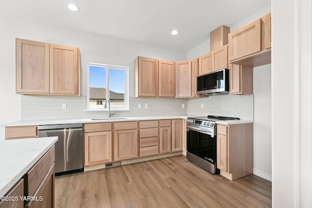 4608 W Larch Ave, Yakima, WA 98908 - kitchen with appliances with stainless steel finishes, light brown cabinetry, light wood-style floors, and recessed lighting