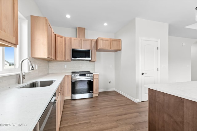 4608 W Larch Ave, Yakima, WA 98908 - kitchen featuring stainless steel appliances, wood finished floors, light countertops, tasteful backsplash, and light brown cabinets