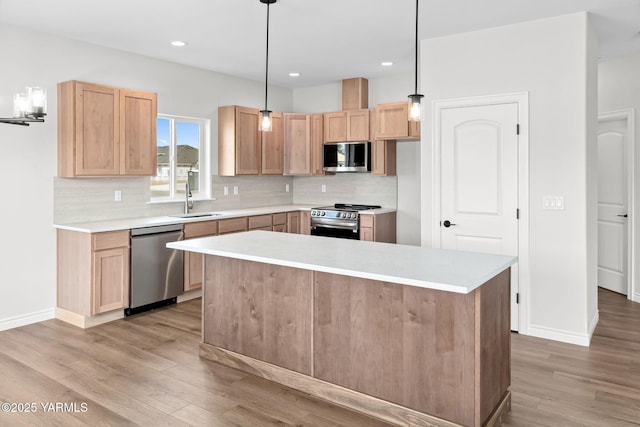 4608 W Larch Ave, Yakima, WA 98908 - kitchen featuring stainless steel appliances, light brown cabinets, light wood finished floors, decorative backsplash, and recessed lighting