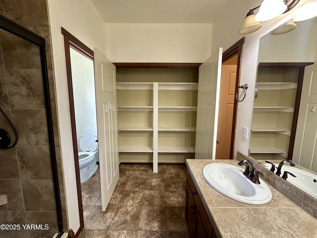 1010 S 89th Ave, Yakima, WA 98908 - bathroom featuring vanity, a shower stall, a spacious closet, and toilet