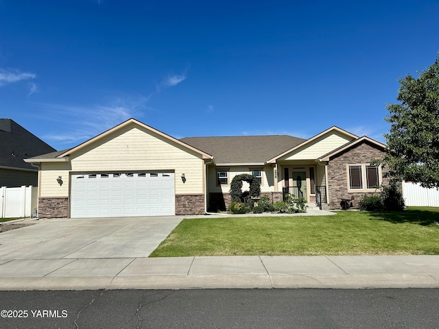1010 S 89th Ave, Yakima, WA 98908 - view of front of property with stone siding, an attached garage, and concrete driveway