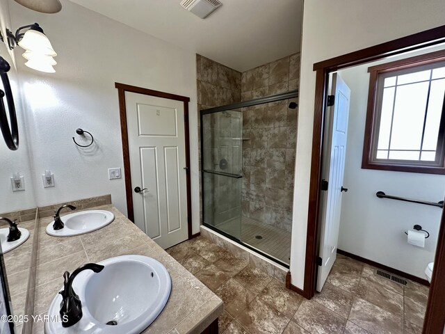 1010 S 89th Ave, Yakima, WA 98908 - bathroom with a stall shower, double vanity, baseboards, and toilet