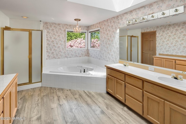 23812 21st Dr Unit Se, Bothell, WA 98021 - full bathroom featuring wallpapered walls, a bath, a sink, a stall shower, and a skylight