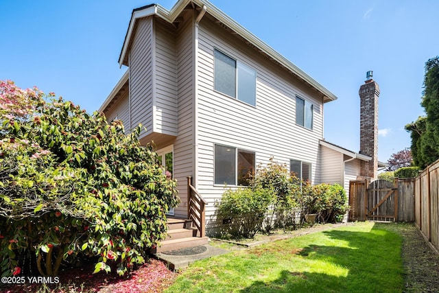 23812 21st Dr Unit Se, Bothell, WA 98021 - rear view of house featuring a gate, fence, a yard, and a chimney