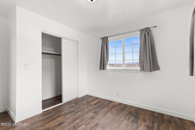 12307 Tieton Dr, Yakima, WA 98908 - unfurnished bedroom with baseboards, a closet, and dark wood-style floors