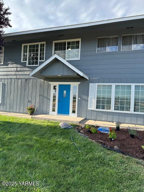 view of front of property featuring board and batten siding and a front yard