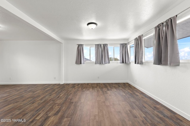 12307 Tieton Dr, Yakima, WA 98908 - empty room with baseboards, dark wood-style flooring, plenty of natural light, and a textured ceiling