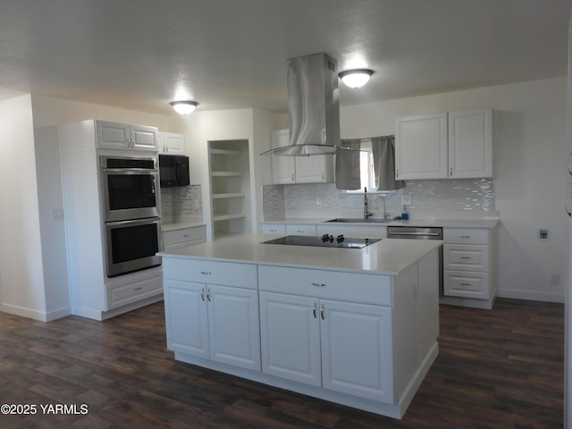 kitchen with a sink, black appliances, white cabinets, and island range hood