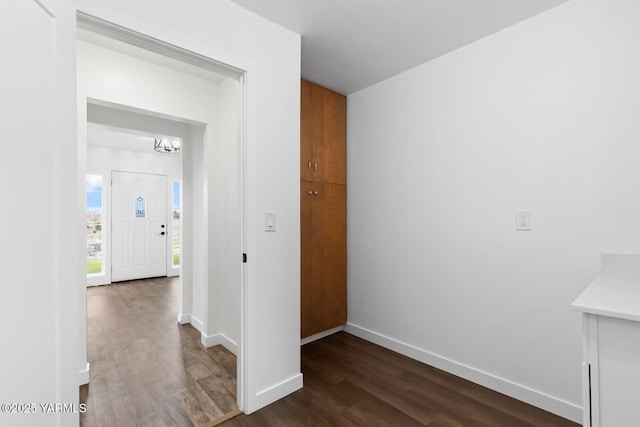 12307 Tieton Dr, Yakima, WA 98908 - hall featuring dark wood-type flooring, baseboards, and a chandelier