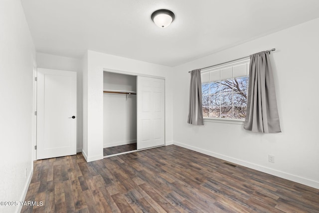 12307 Tieton Dr, Yakima, WA 98908 - unfurnished bedroom featuring wood finished floors, baseboards, and a closet