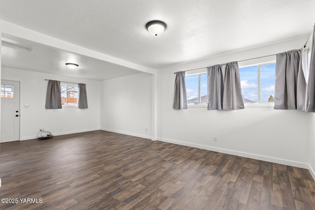 12307 Tieton Dr, Yakima, WA 98908 - unfurnished room with baseboards, dark wood-type flooring, and a textured ceiling