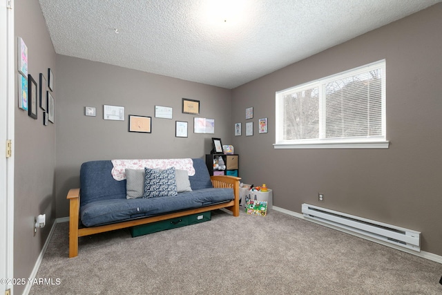 sitting room featuring carpet floors, a baseboard radiator, baseboards, and a textured ceiling