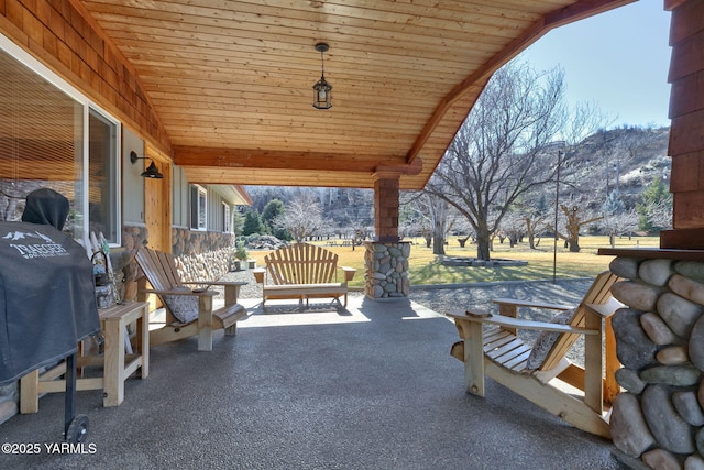 view of patio / terrace featuring covered porch, grilling area, and a mountain view