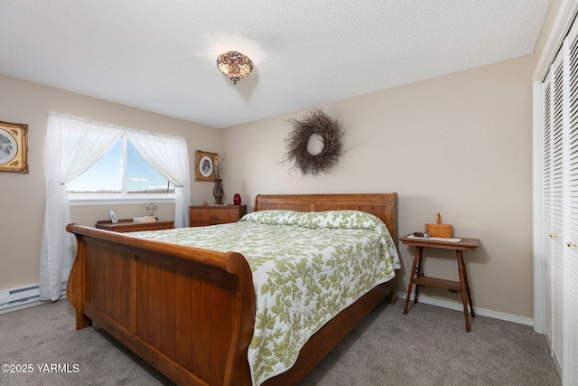 bedroom featuring a textured ceiling, baseboards, a closet, and light colored carpet