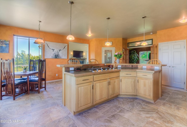 11901 Zier Rd, Yakima, WA 98908 - kitchen with healthy amount of natural light, stainless steel gas stovetop, light brown cabinets, and a kitchen island