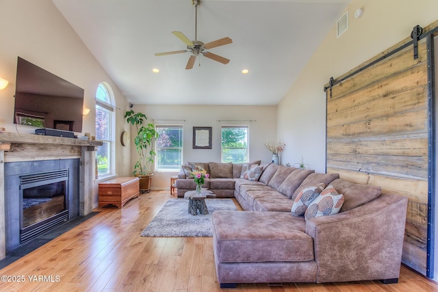 11901 Zier Rd, Yakima, WA 98908 - living area with a barn door, light wood-style floors, ceiling fan, a fireplace with flush hearth, and recessed lighting