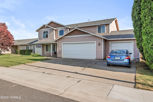 506 Millenium Ave, Moxee, WA 98936 - traditional-style house featuring concrete driveway, a garage, a front lawn, and roof with shingles