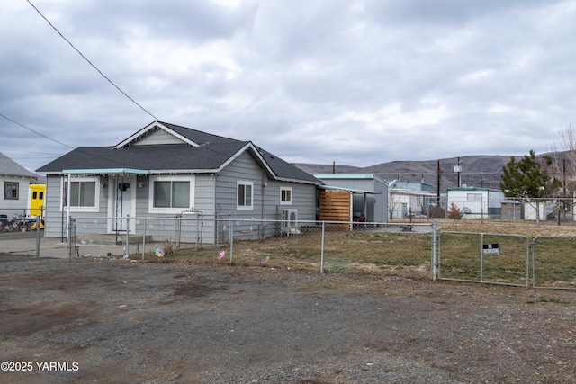 view of front of house with a fenced front yard and a gate