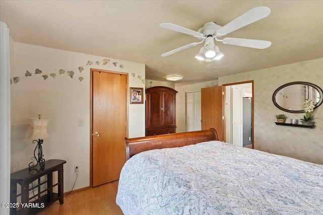 10401 N 1739th Pr NW, Grandview, WA 98930 - bedroom with light wood-style flooring, multiple closets, and ceiling fan