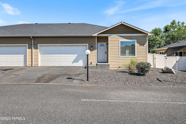 3101 Swan Ave, Yakima, WA 98902 - view of front of property featuring an attached garage, asphalt driveway, and a gate