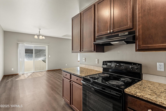 3101 Swan Ave, Yakima, WA 98902 - kitchen with black range with electric stovetop, under cabinet range hood, a chandelier, wood finished floors, and light stone countertops