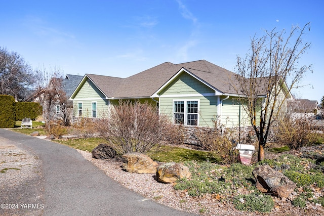 single story home with roof with shingles