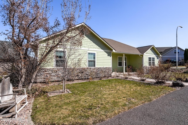 ranch-style home featuring a front yard