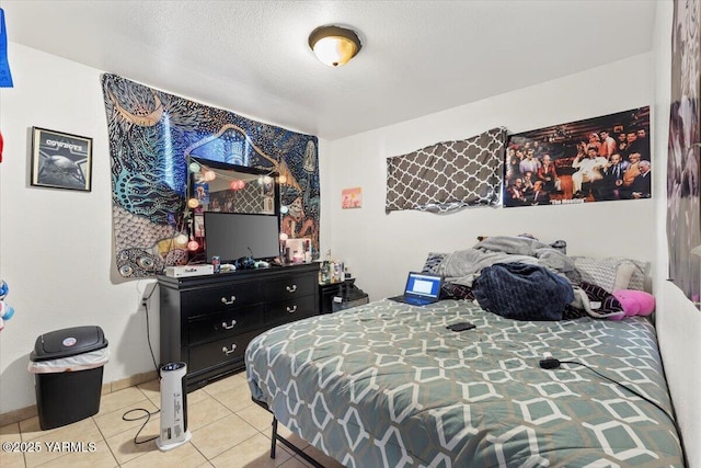 tiled bedroom featuring baseboards