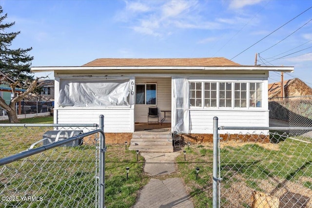 bungalow with a gate, a front yard, fence, and a sunroom