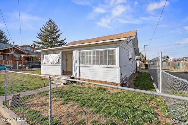 bungalow-style home featuring fence