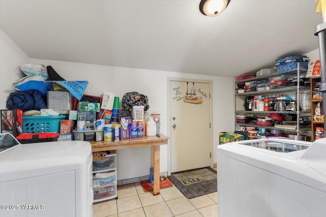 laundry room with laundry area, independent washer and dryer, a textured ceiling, and light tile patterned floors