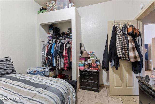 bedroom with light tile patterned floors and a closet