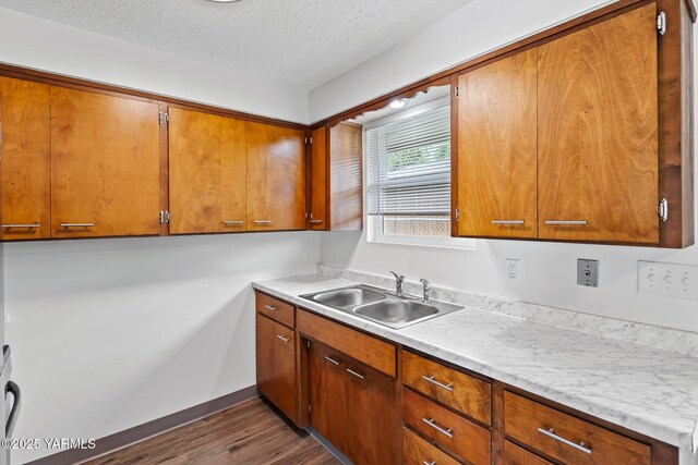 904 S 42nd Ave Unit A, B, C, D, Yakima, WA 98908 - kitchen with stainless steel appliances, brown cabinets, wood finished floors, a textured ceiling, and light countertops