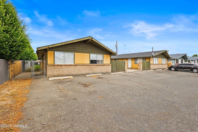 904 S 42nd Ave Unit A, B, C, D, Yakima, WA 98908 - view of front of property featuring a gate, brick siding, and uncovered parking