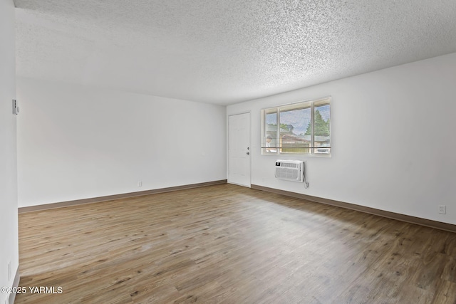 904 S 42nd Ave Unit A, B, C, D, Yakima, WA 98908 - spare room with a textured ceiling, wood finished floors, and an AC wall unit