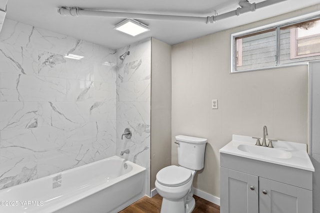 bathroom with toilet, washtub / shower combination, vanity, wood finished floors, and baseboards