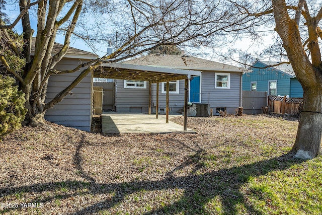 back of property featuring entry steps, a carport, a patio area, and fence