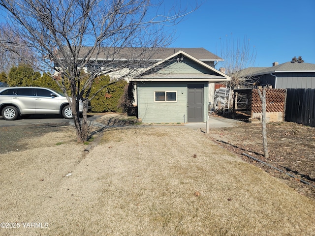 exterior space featuring an outdoor structure and fence