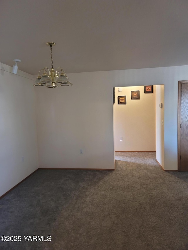 carpeted empty room with a notable chandelier