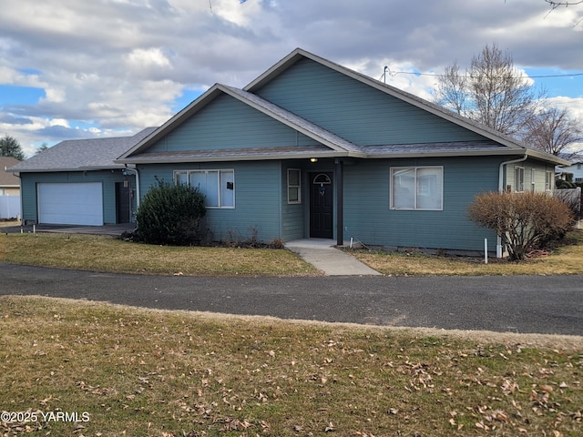 view of front of house featuring a garage and a front yard