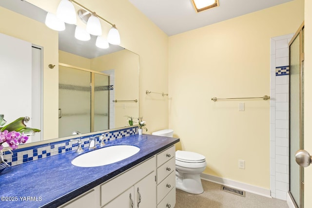 bathroom with toilet, visible vents, a shower stall, and vanity
