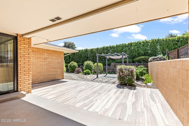 view of patio featuring a pergola, visible vents, fence, and a deck